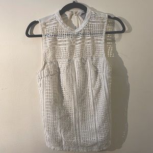 Sleeveless white top. Great w/ jeans or khakis.